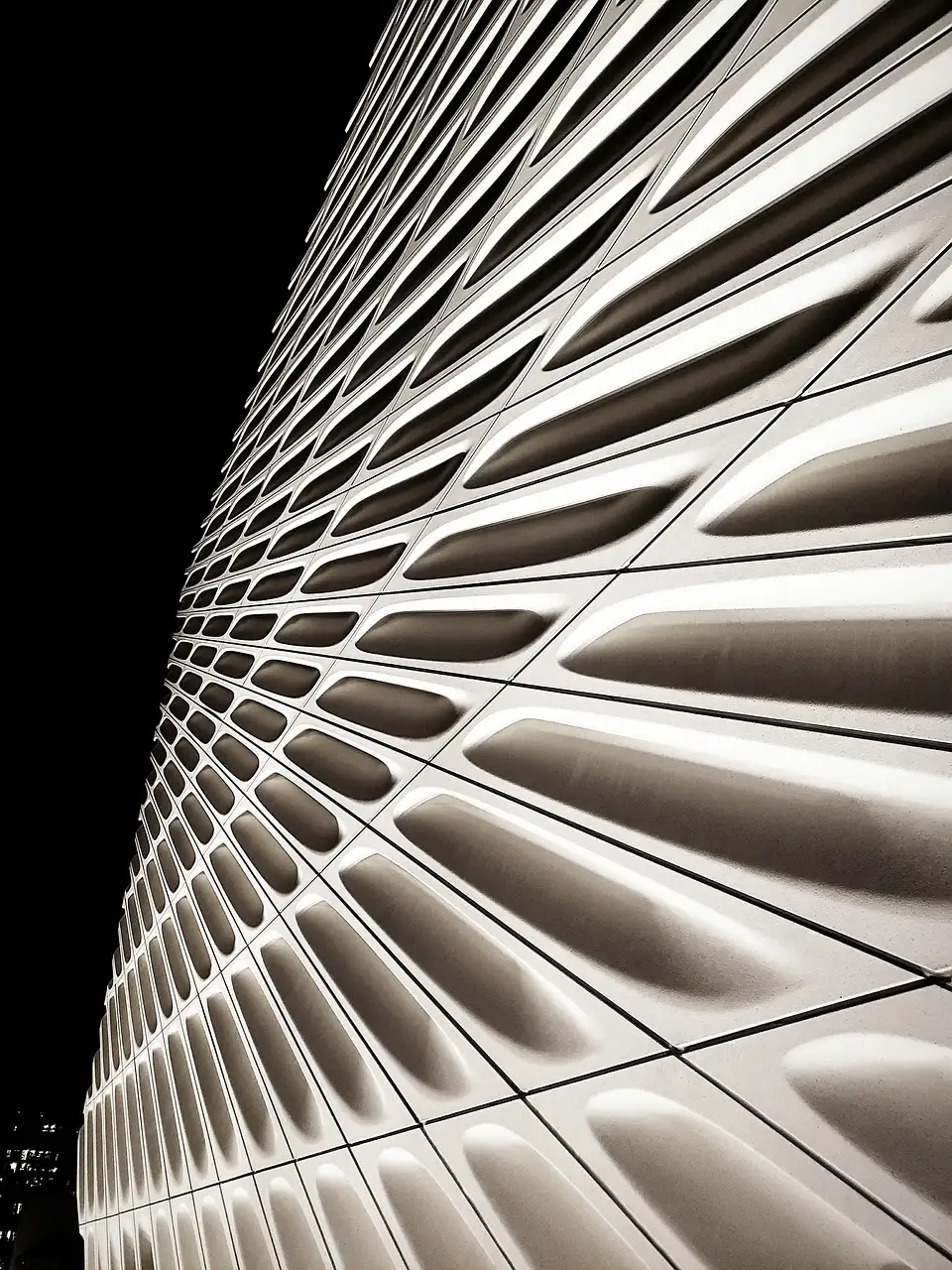 The white honeycomb facade of The Broad museum at night