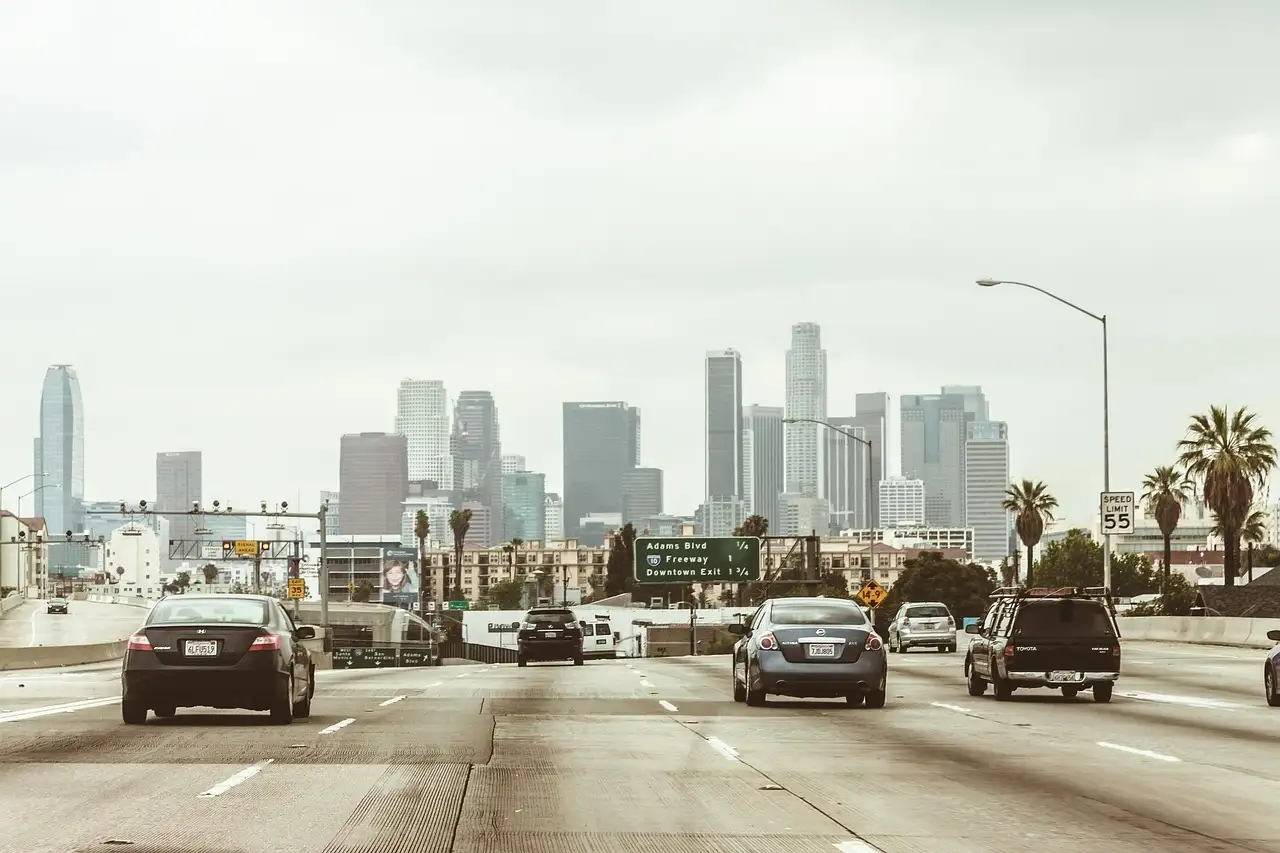 A busy freeway running past the towers of downtown Los Angeles
