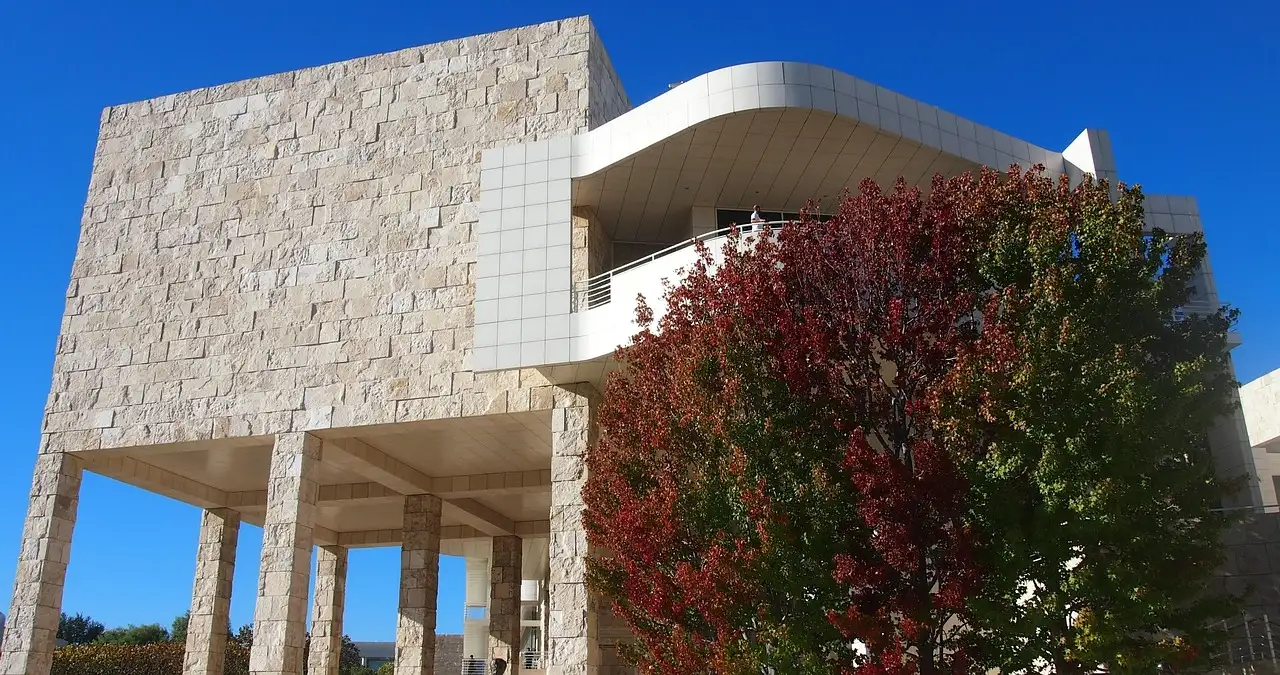 Travertine stone and white panels of a Getty Center building under a blue sky