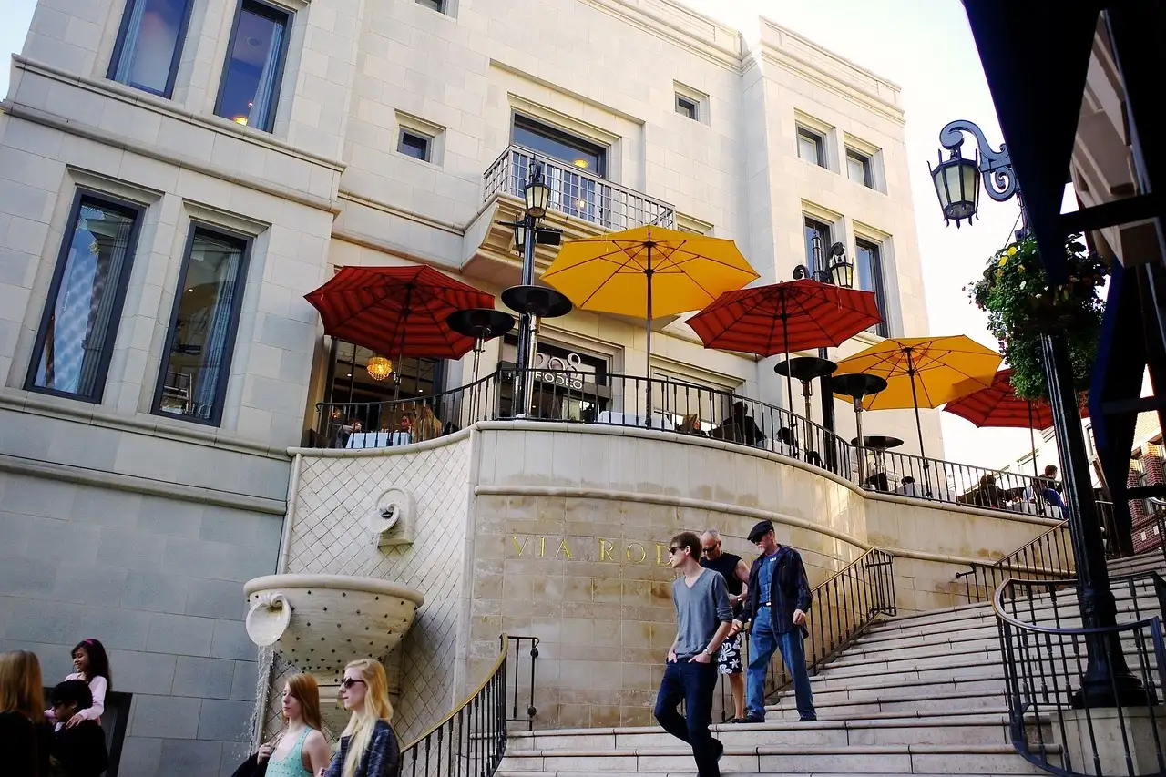 Stone steps and cafe umbrellas on a shopping street in Beverly Hills