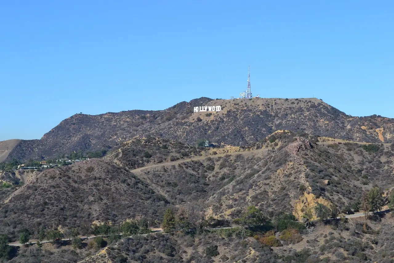 Dry hills and trails of Griffith Park with the Hollywood Sign small on the ridge