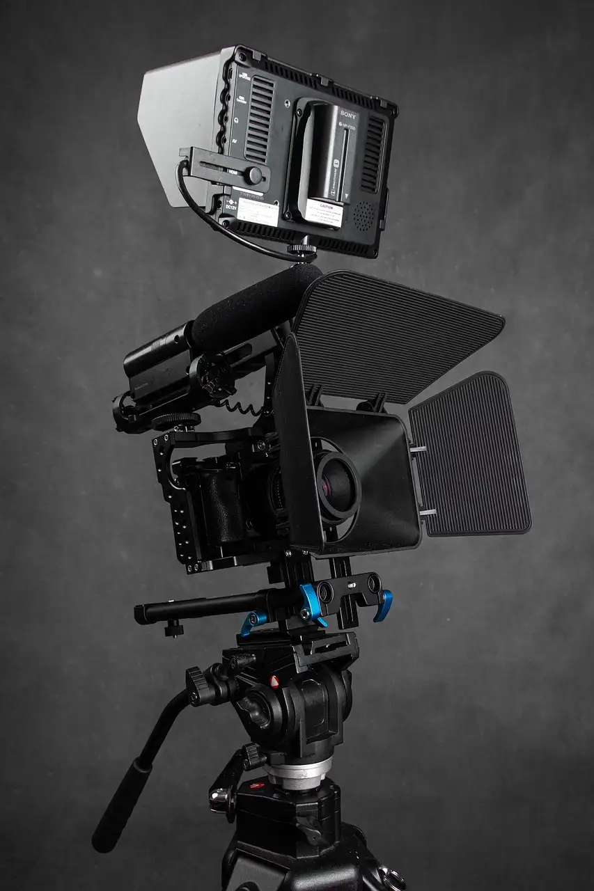 A cinema camera on a tripod in a grey studio