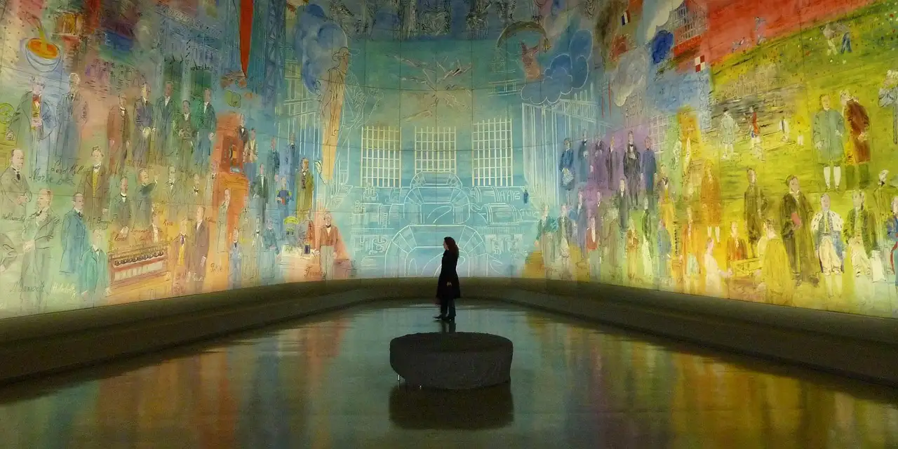 A visitor standing before a huge, colorful curved mural in a dim gallery