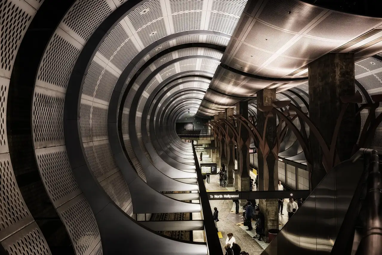Curved metal tunnel ceiling and platform of the Hollywood/Vine Metro station in Los Angeles