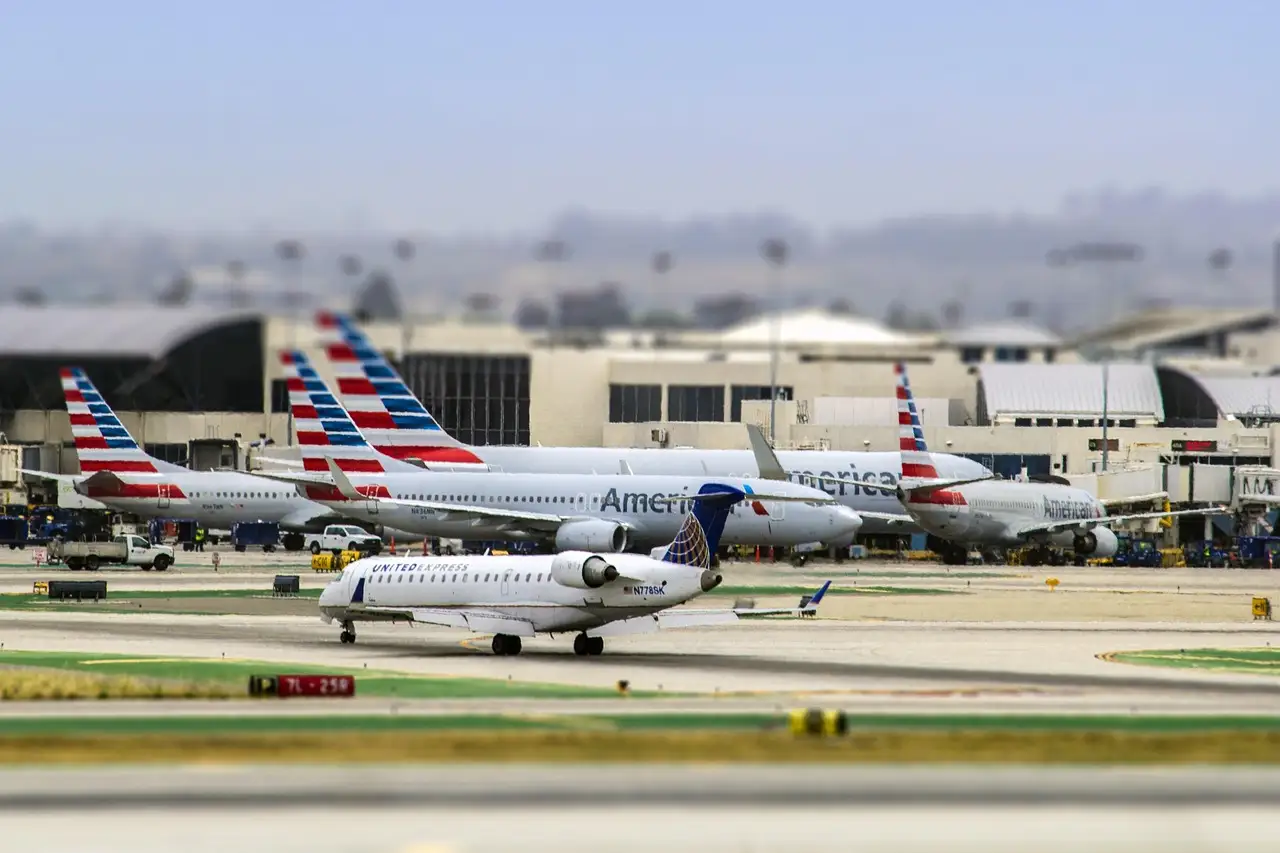 Planes parked at the terminals of Los Angeles International Airport (LAX) beside the runway