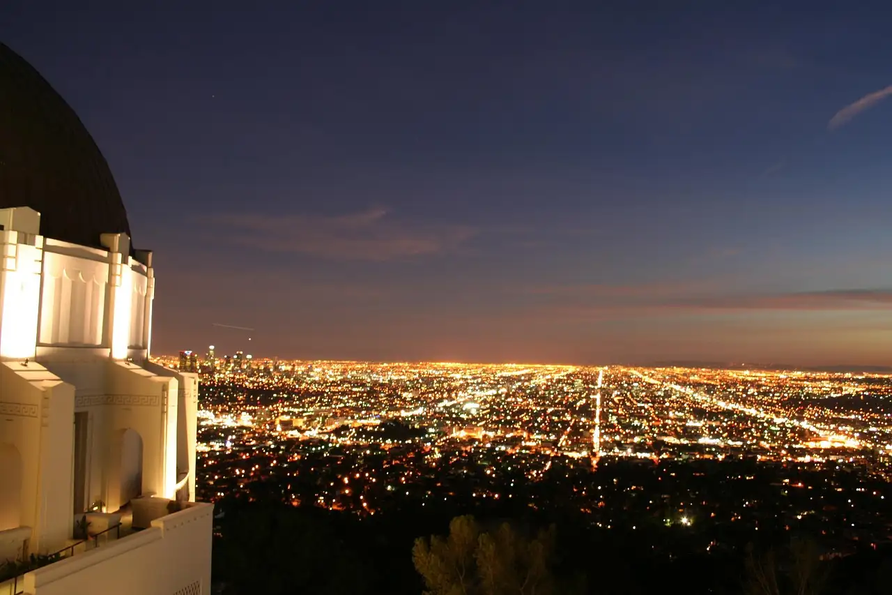 Griffith Observatory above the glowing lights of Los Angeles at dusk