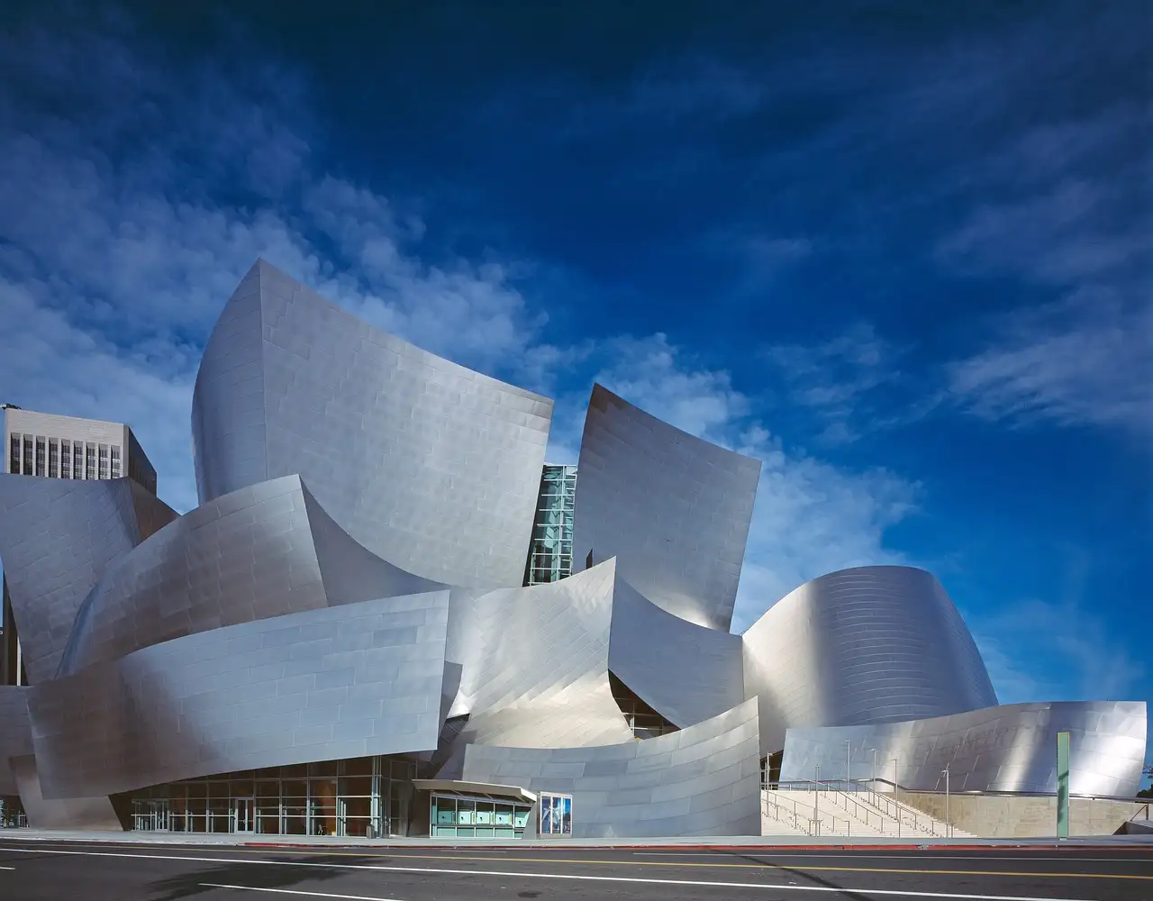 The curved steel walls of Walt Disney Concert Hall in Downtown Los Angeles under a deep blue sky