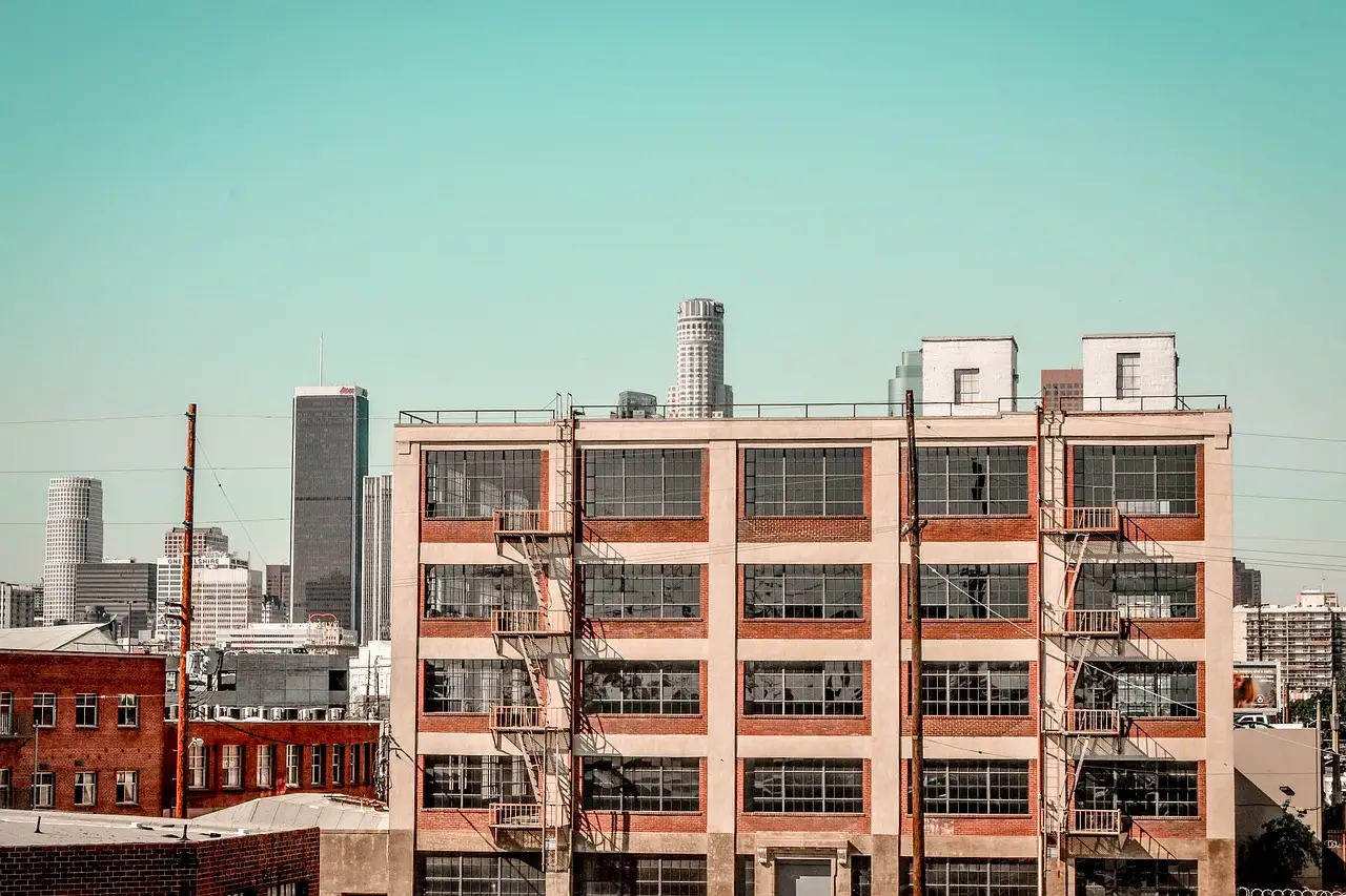 Brick warehouse buildings in the Arts District with the downtown Los Angeles towers behind