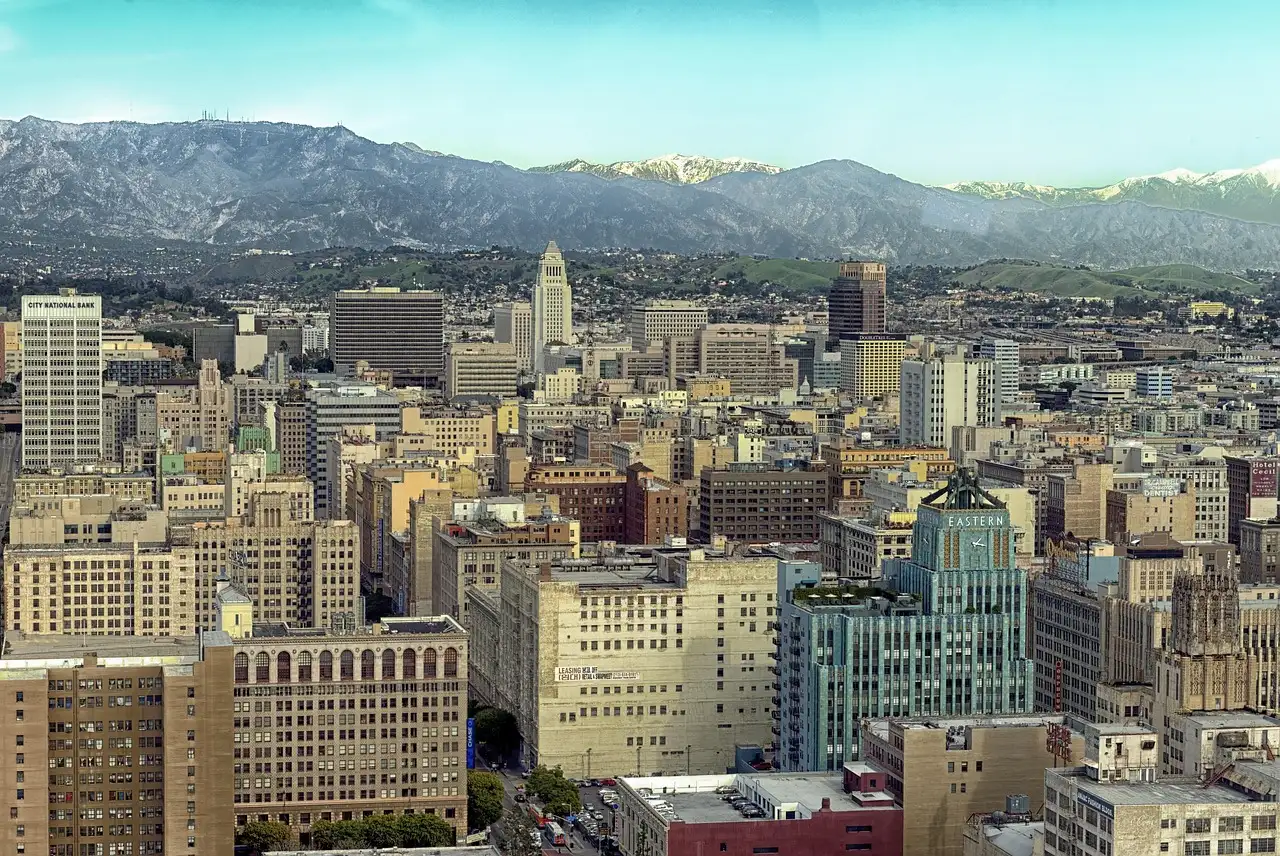 Downtown Los Angeles with City Hall and snow on the San Gabriel Mountains behind