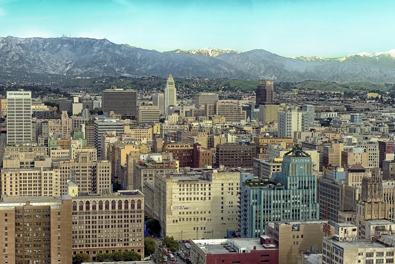 Downtown Los Angeles with City Hall and snow on the San Gabriel Mountains behind