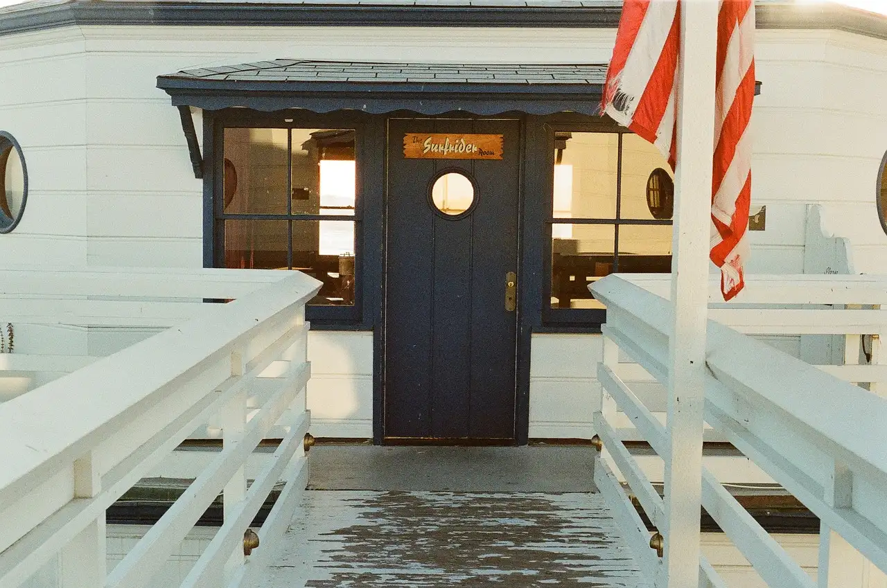 The white entrance building on Malibu Pier with a US flag