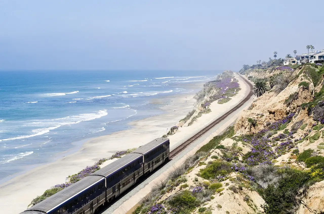 Pacific Surfliner train running along the coastal cliffs above the beach at Del Mar