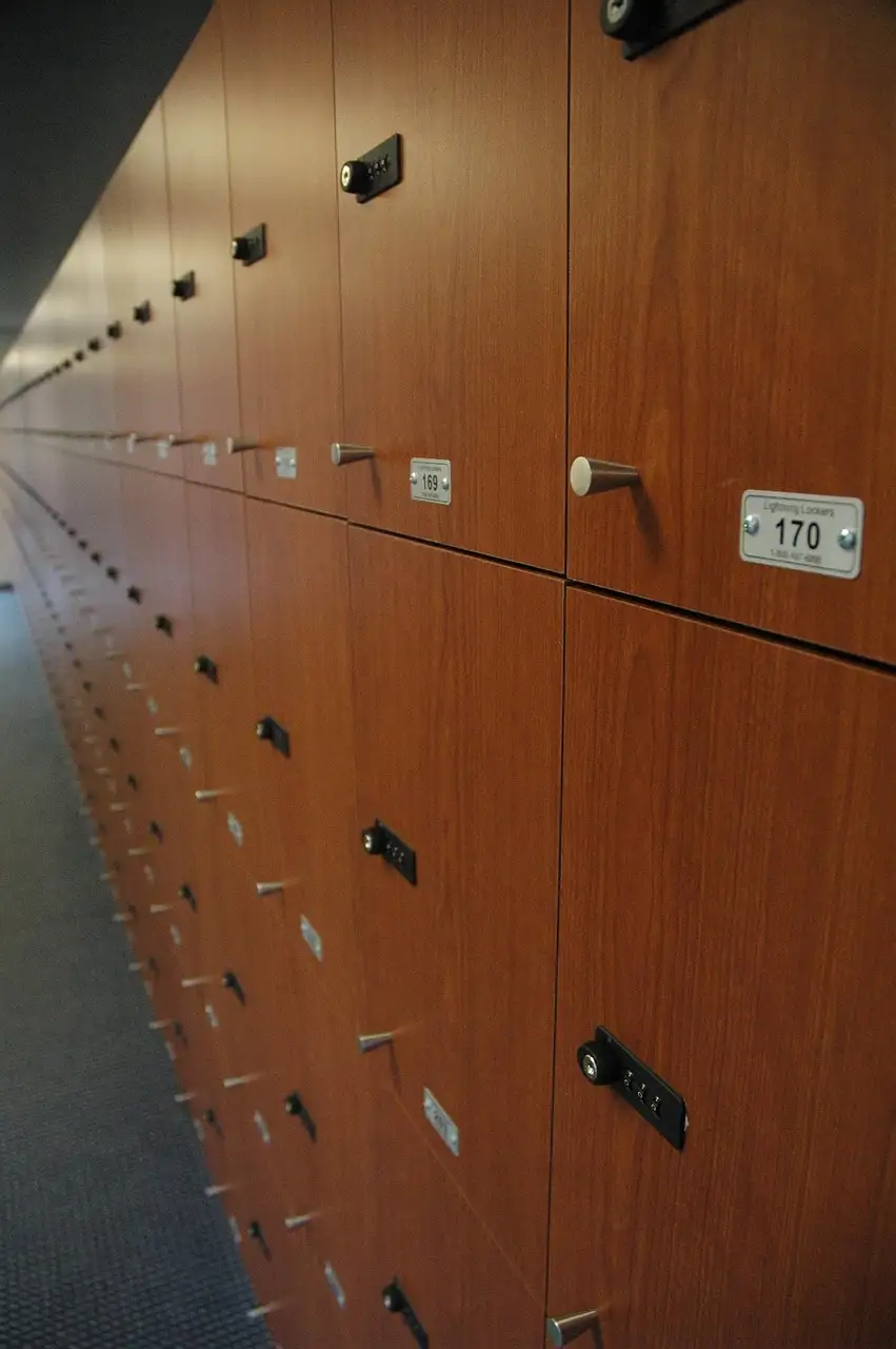 A row of wooden lockers in a stadium changing room