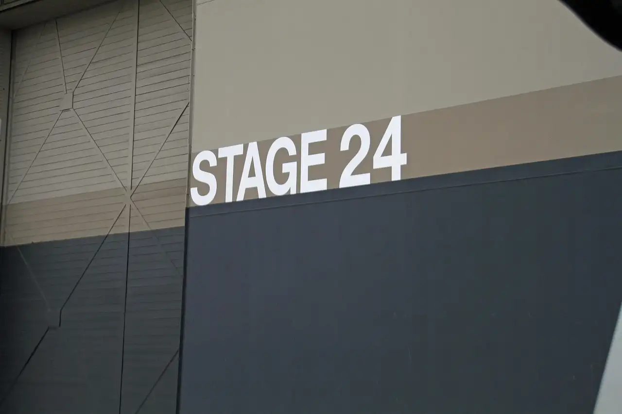 The grey wall of a film soundstage marked Stage 24