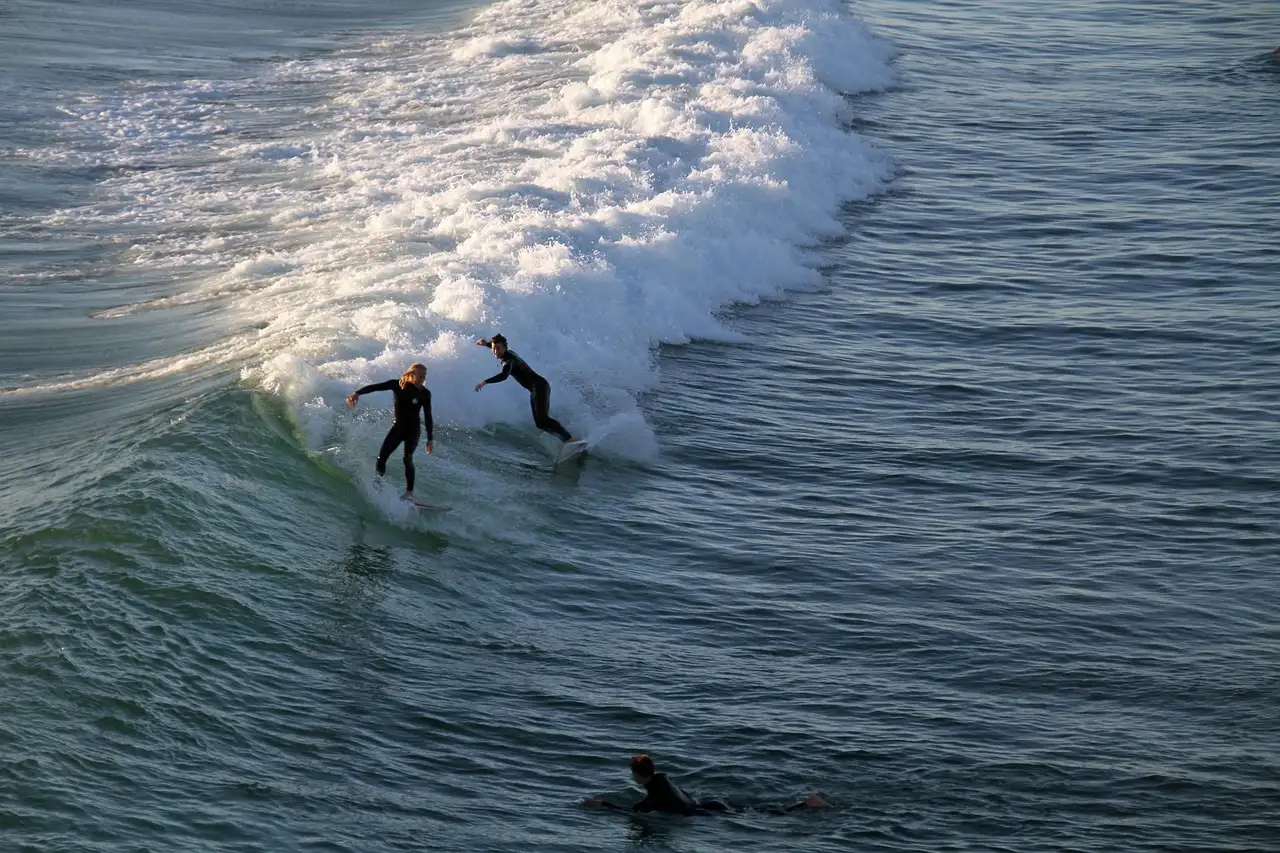 Two surfers riding a wave off the California coast