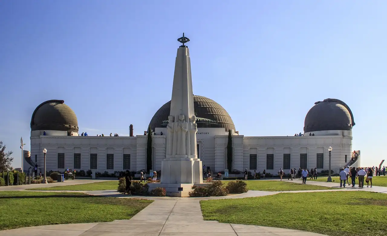 Griffith Observatory with its three domes and the Astronomers Monument on the front lawn