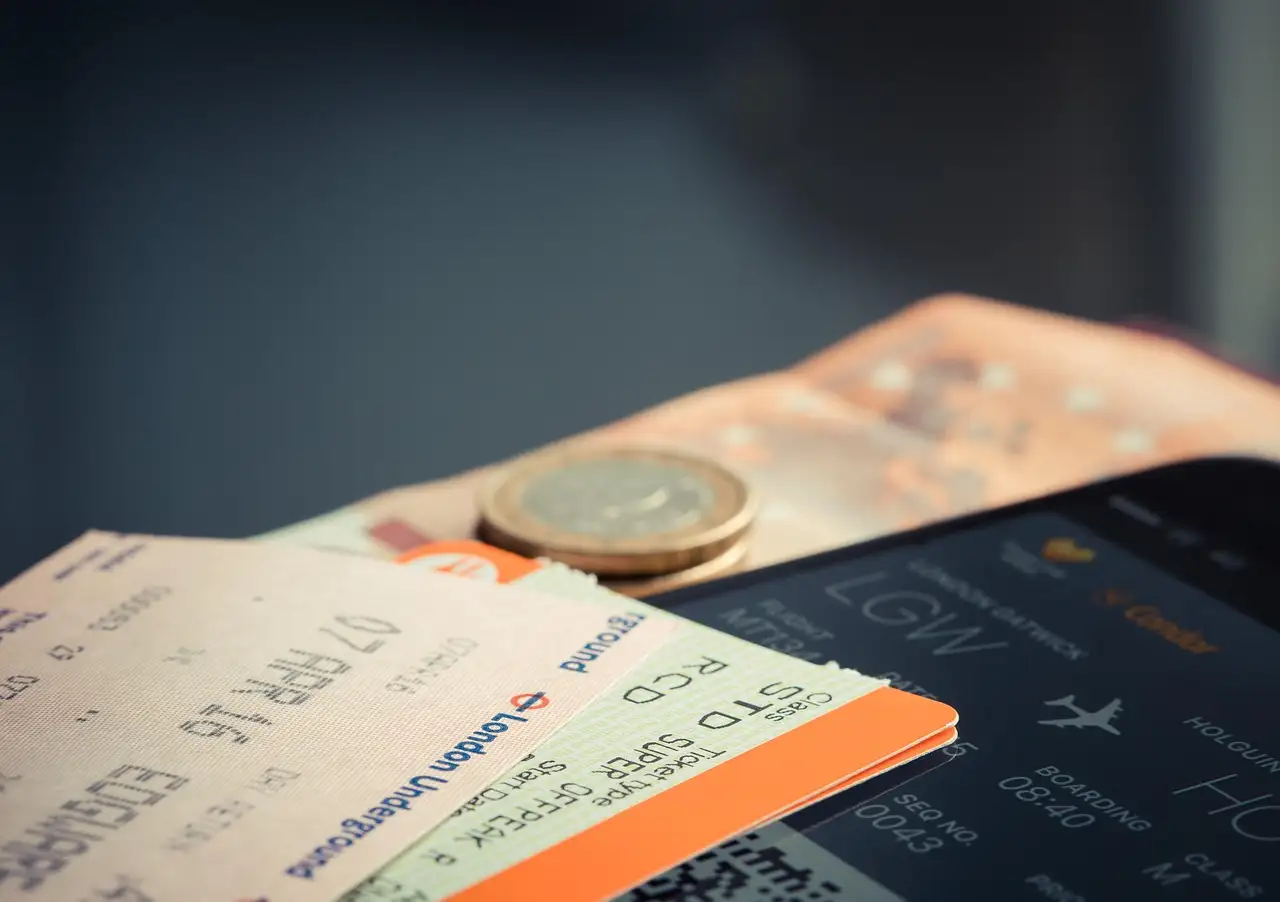 Paper tickets and a coin lying on a phone