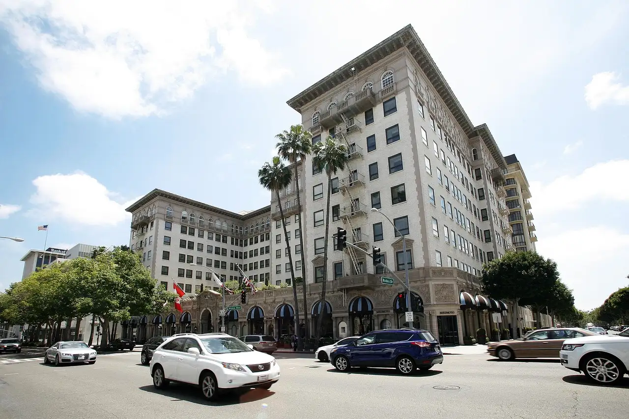 A grand cream-colored hotel with palm trees on Wilshire Boulevard in Beverly Hills