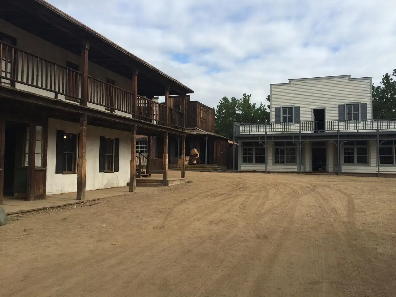 Wooden storefronts around a dirt street on an old Western movie set near Los Angeles
